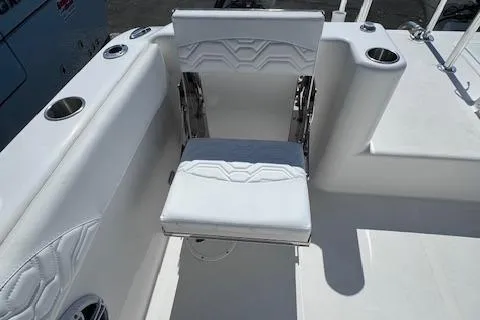Slide: The Image of 2023 Twin Vee 280 GFX CC boat with white seating and cup holders. - 22