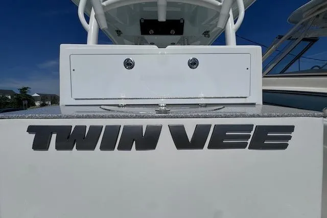 Slide: The Image of 2023 Twin Vee 280 GFX CC boat, rear view with logo and sleek design. - 24