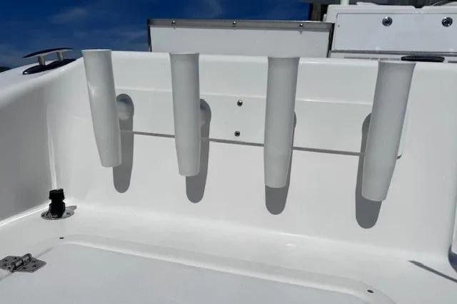 Slide: The Image of 2023 Twin Vee 280 GFX CC boat rod holders against a clear blue sky. - 26