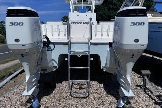 Slide: The Image of 2023 Twin Vee 280 GFX CC boat with dual Suzuki 300 engines, rear view. - 4