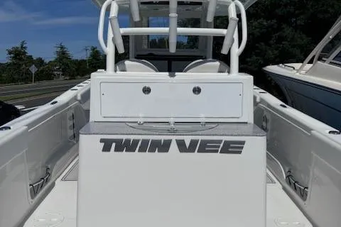 Slide: The Image of 2023 Twin Vee 280 GFX CC boat, white deck, center console, outdoor setting. - 8