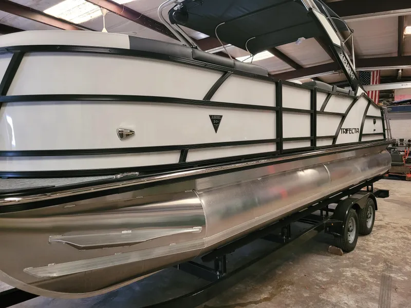 The Image of 2023 Trifecta 24' SB2 ARCH SS 3 Plus pontoon boat in a showroom. - 0