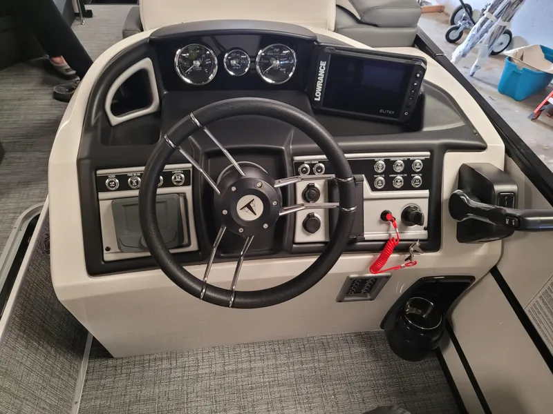Slide: The Image of 2023 Trifecta 24' SB2 ARCH SS 3 Plus boat dashboard with steering wheel and control panel. - 15