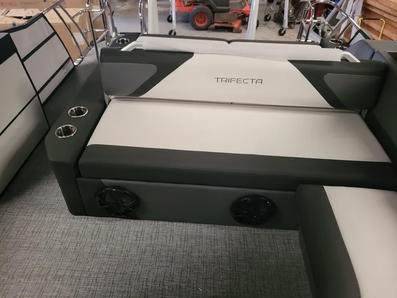 Slide: The Image of 2023 Trifecta 24' SB2 ARCH SS 3 Plus boat interior with cushioned seating and cup holders. - 4