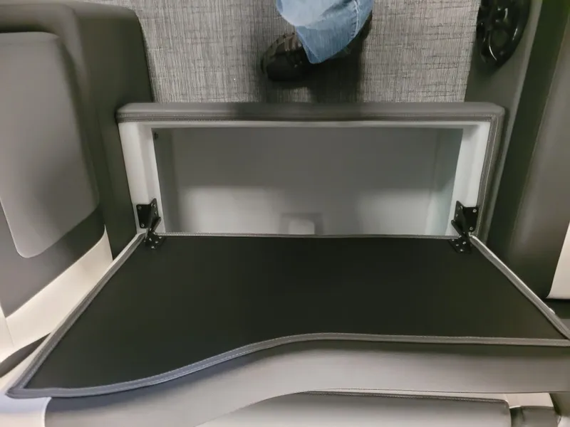 Slide: The Image of 2023 Trifecta 24' SB2 ARCH SS 3 Plus storage compartment with open lid and carpeted flooring. - 8