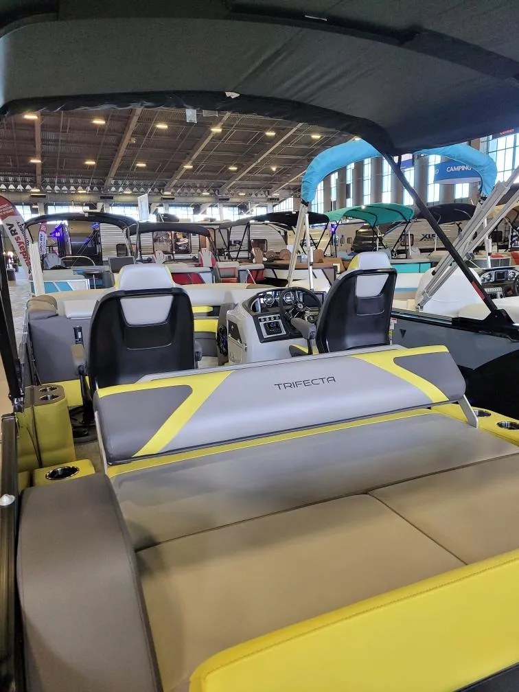 Slide: The Image of Trifecta 2023 23 UL SS pontoon boat interior at a boat show display. - 15
