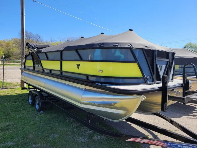 Slide: The Image of 2023 Trifecta 23 UL SS pontoon boat with yellow and black design on a trailer. - 17