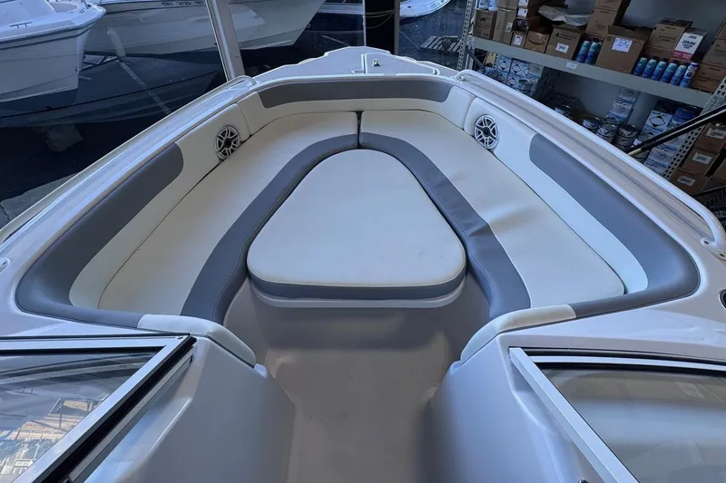 Slide: The Image of Interior of 2023 Release 230 DC boat with cushioned seating and speakers. - 3