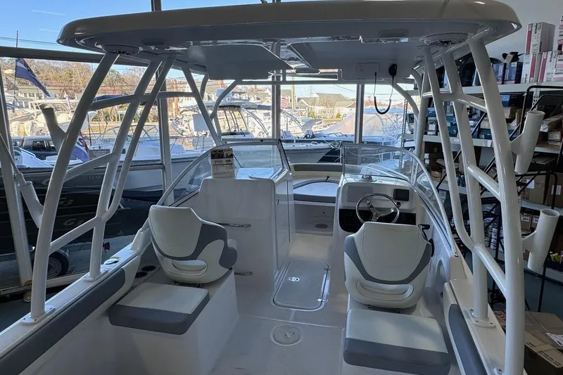 Slide: The Image of Interior view of 2023 Release 230 DC boat with seating and steering wheel. - 6