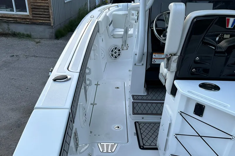 Slide: The Image of 2021 Wellcraft 262 Fisherman boat interior, featuring a clean deck and modern controls. - 11