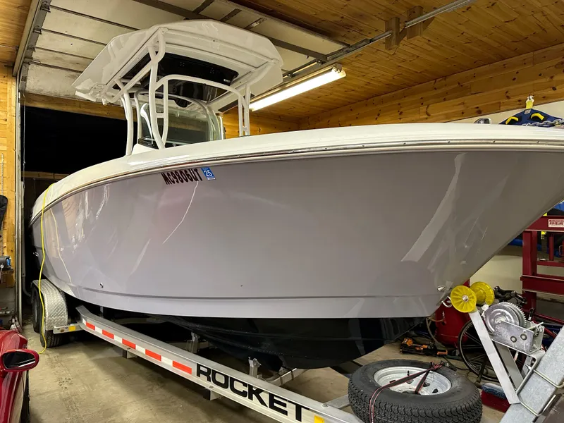 Slide: The Image of 2021 Wellcraft 262 Fisherman boat on trailer in a garage. - 14