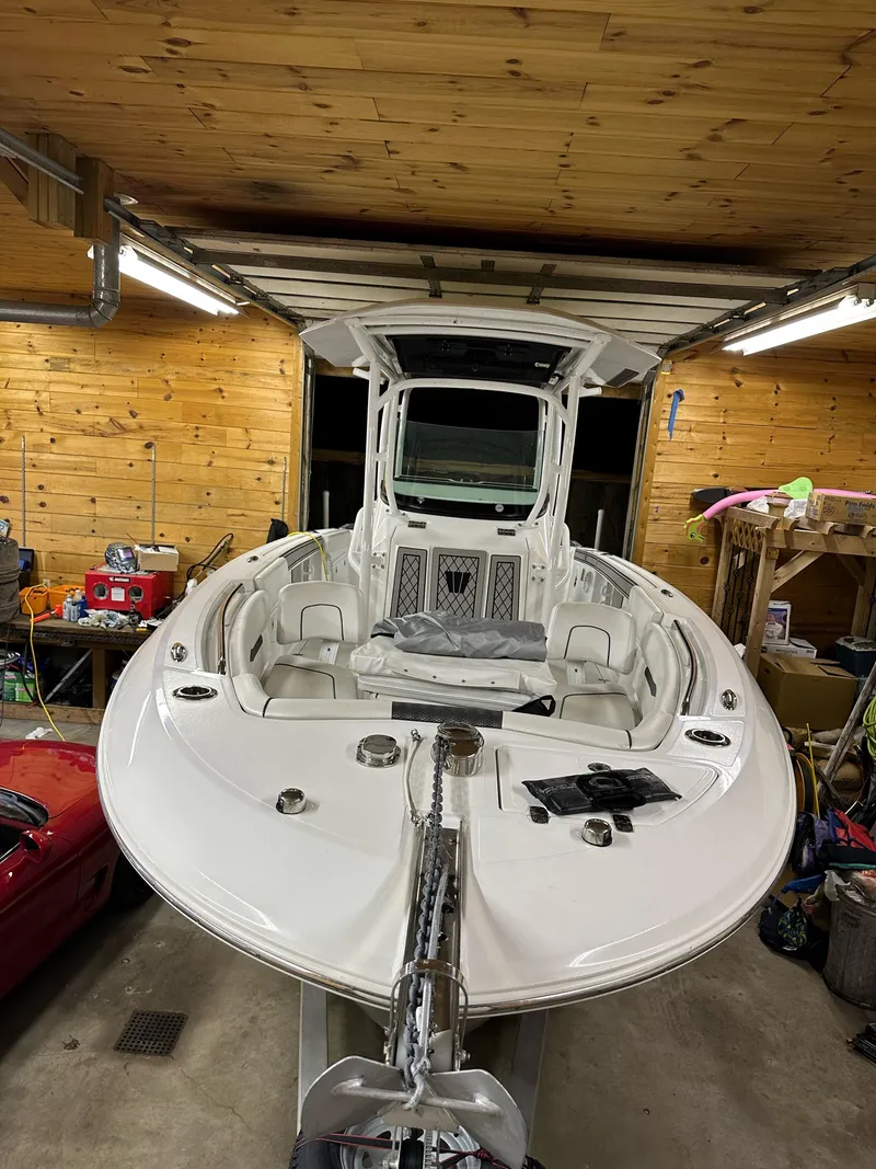 Slide: The Image of 2021 Wellcraft 262 Fisherman boat in a wooden garage, front view. - 15