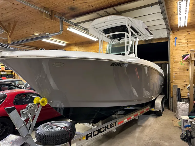 Slide: The Image of 2021 Wellcraft 262 Fisherman boat on trailer in a wooden garage. - 16