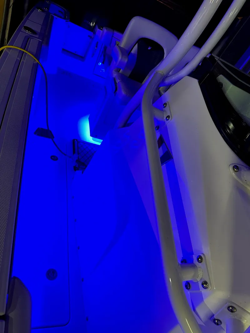 Slide: The Image of 2021 Wellcraft 262 Fisherman boat interior with blue LED lighting. - 18