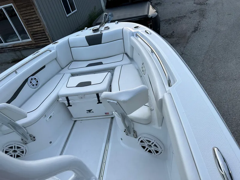 Slide: The Image of 2021 Wellcraft 262 Fisherman boat interior with white seating and storage compartments. - 2