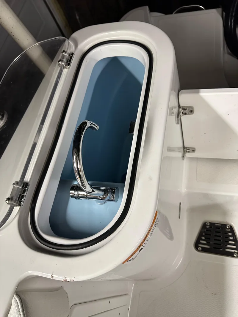 Slide: The Image of 2021 Wellcraft 262 Fisherman boat livewell with chrome faucet and white interior. - 26