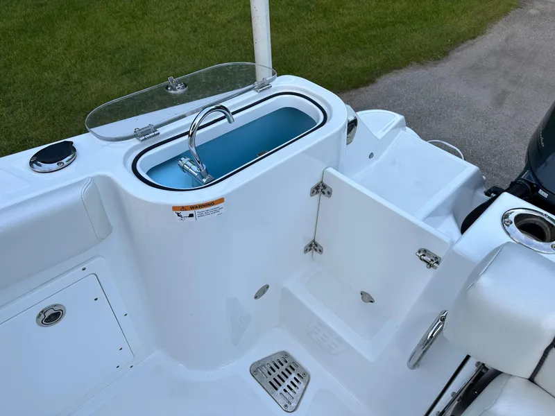 Slide: The Image of 2021 Wellcraft 262 Fisherman boat interior with livewell and seating area. - 3