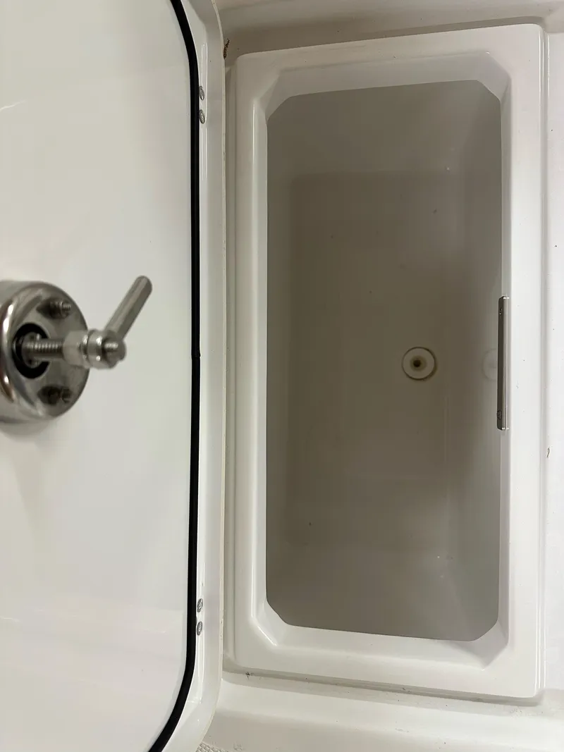 Slide: The Image of 2021 Wellcraft 262 Fisherman boat compartment with stainless steel handle. - 34