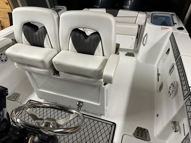 Slide: The Image of 2021 Wellcraft 262 Fisherman boat interior with dual seats and steering wheel. - 39