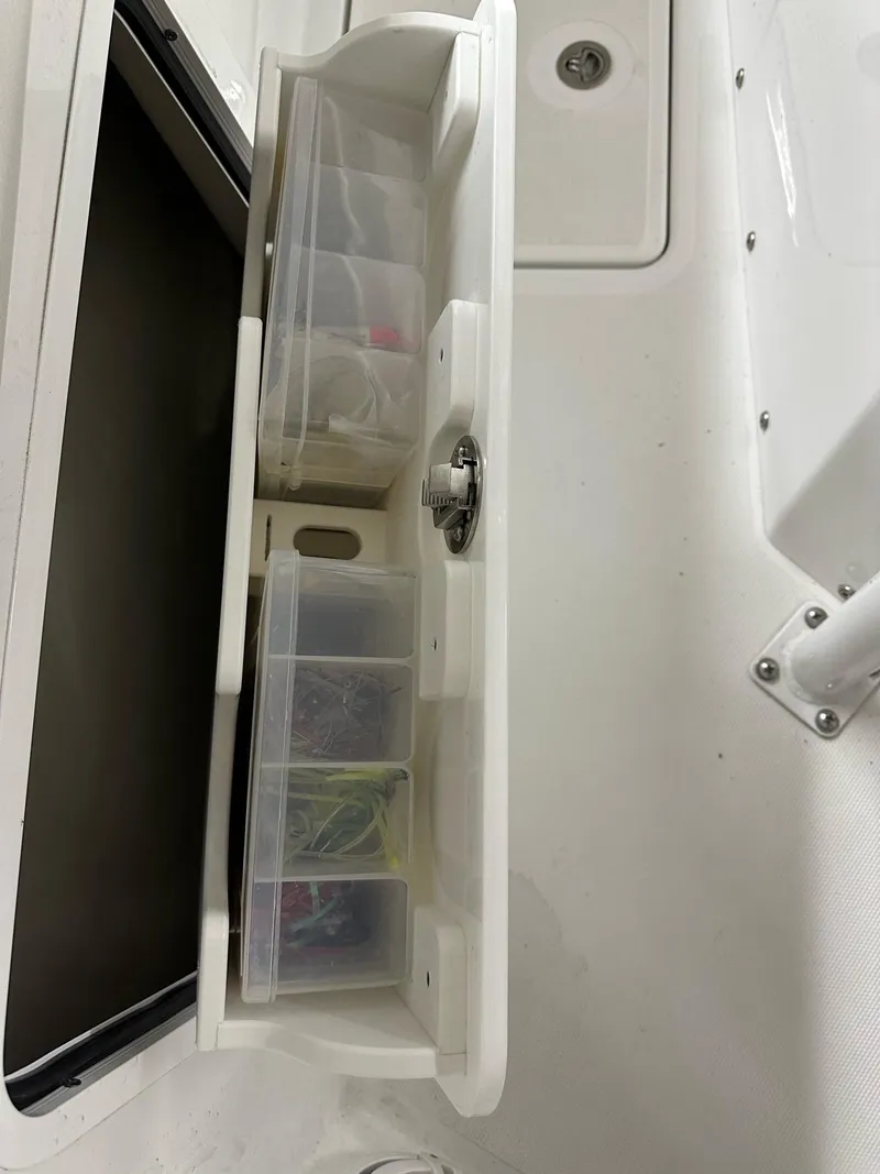 Slide: The Image of Storage compartment on 2021 Wellcraft 262 Fisherman boat with organized tackle boxes. - 41