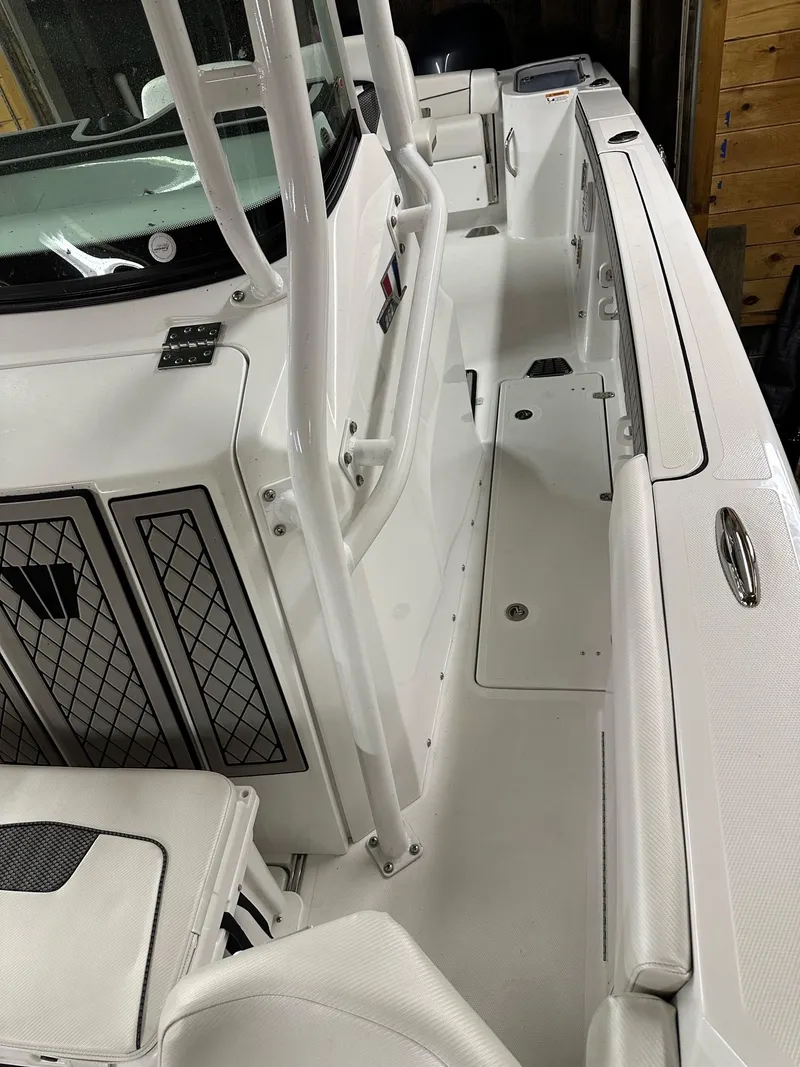 Slide: The Image of 2021 Wellcraft 262 Fisherman boat interior, featuring sleek white design and spacious deck layout. - 43