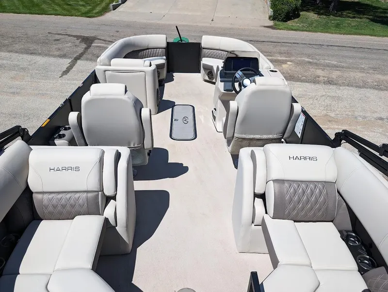 Slide: The Image of 2024 Harris Sunliner 250 pontoon boat interior with luxurious seating and modern helm. - 16