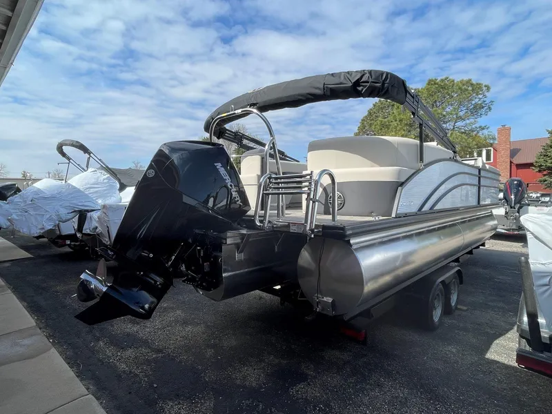 Slide: The Image of 2024 Harris Sunliner 250 pontoon boat with outboard motor on trailer. - 3