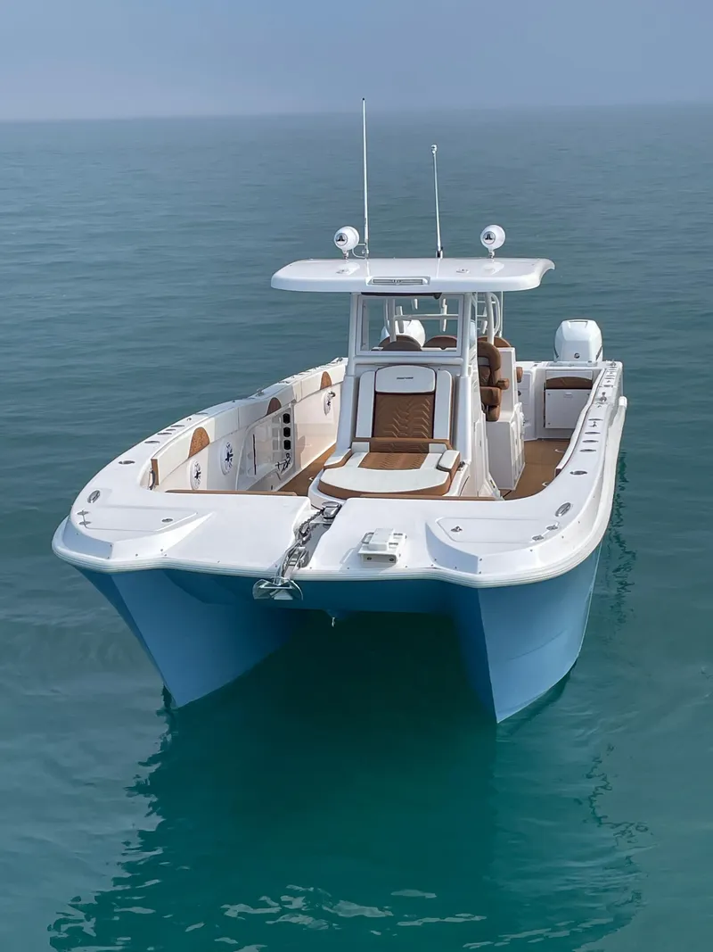 Slide: The Image of 2023 Twin Vee 340 GFX boat on calm ocean waters. - 10