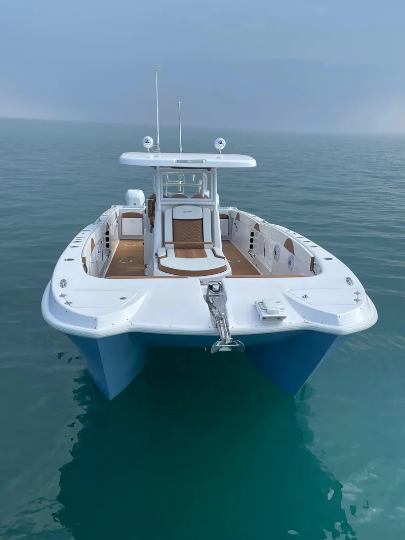 Slide: The Image of 2023 Twin Vee 340 GFX boat on calm ocean water. - 11