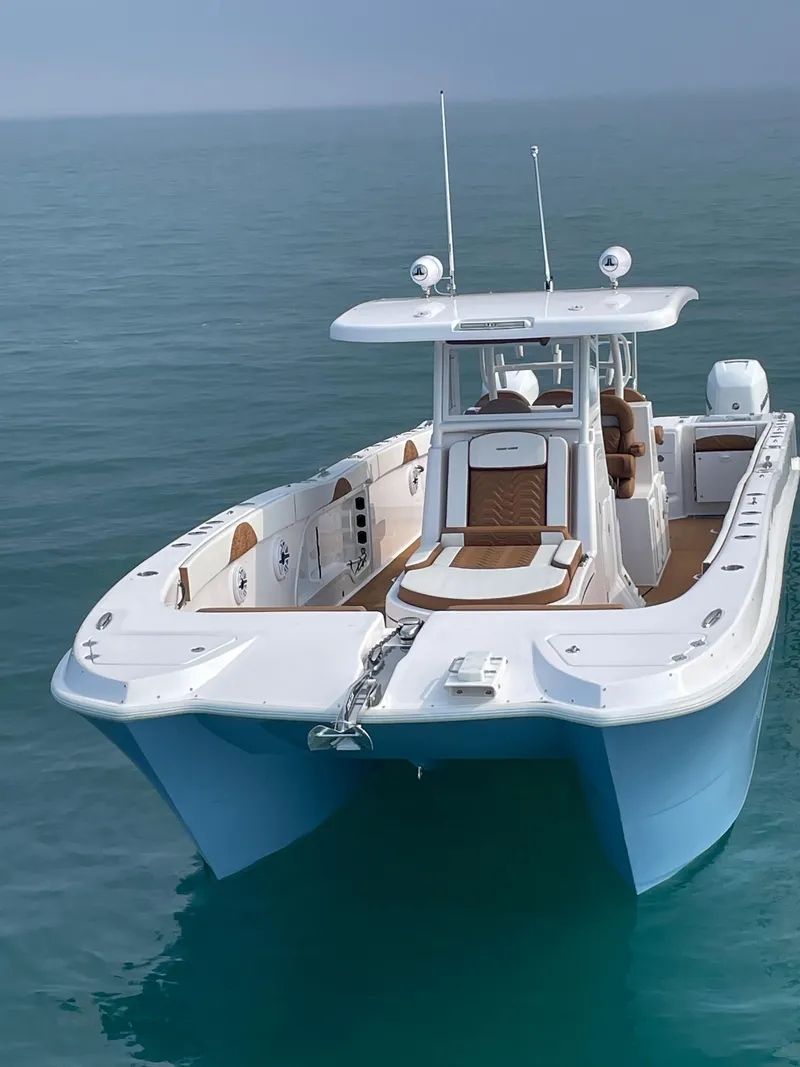 Slide: The Image of 2023 Twin Vee 340 GFX boat on calm ocean water. - 12