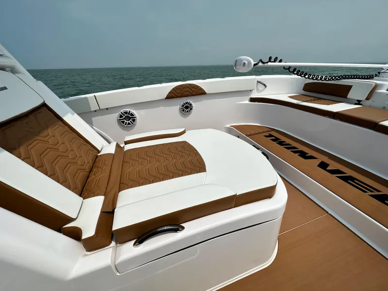 Slide: The Image of 2023 Twin Vee 340 GFX boat interior with brown and white seating. - 19