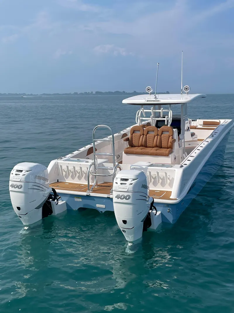 Slide: The Image of 2023 Twin Vee 340 GFX boat with dual 400 HP engines on open water. - 2