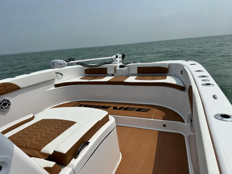 Slide: The Image of 2023 Twin Vee 340 GFX boat interior with brown and white seating on open water. - 20