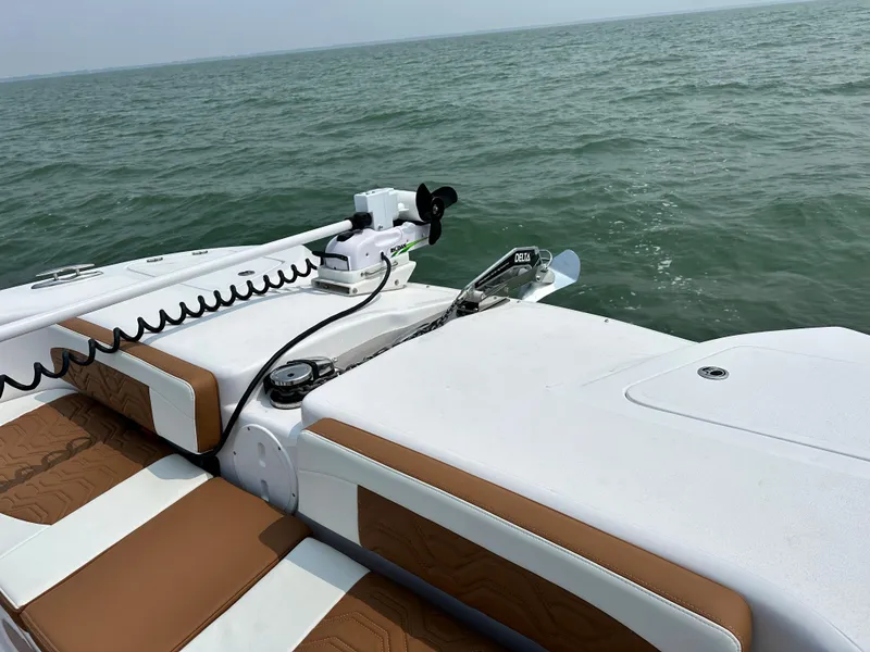 Slide: The Image of 2023 Twin Vee 340 GFX boat with brown and white seating on the water. - 21