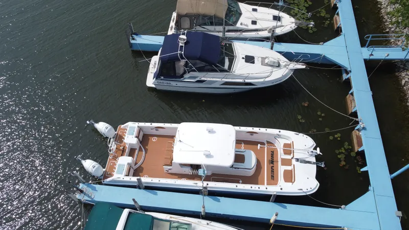 Slide: The Image of 2023 Twin Vee 340 GFX boat docked at marina, aerial view. - 23