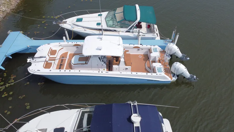 Slide: The Image of 2023 Twin Vee 340 GFX boat docked with twin outboard engines. - 24