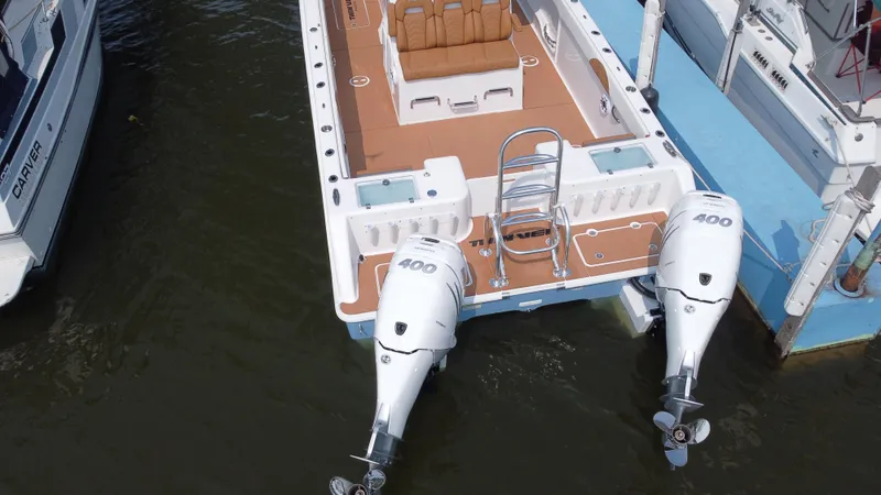 Slide: The Image of 2023 Twin Vee 340 GFX boat with dual 400 horsepower engines docked. - 26