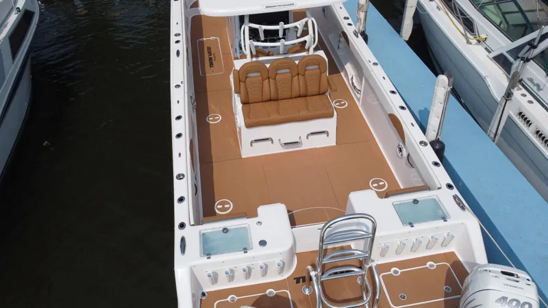 Slide: The Image of 2023 Twin Vee 340 GFX boat docked, featuring spacious seating and modern amenities. - 27