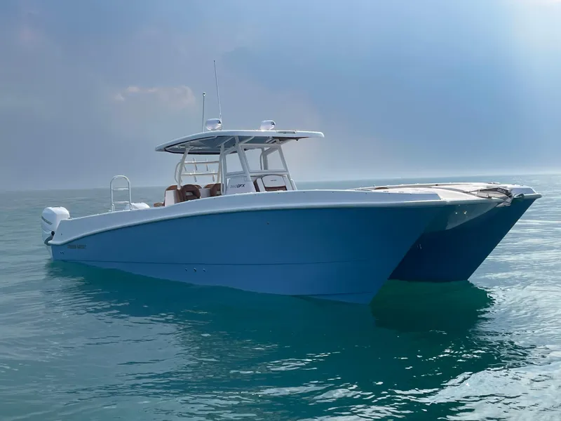 Slide: The Image of 2023 Twin Vee 340 GFX catamaran boat on calm ocean waters. - 3