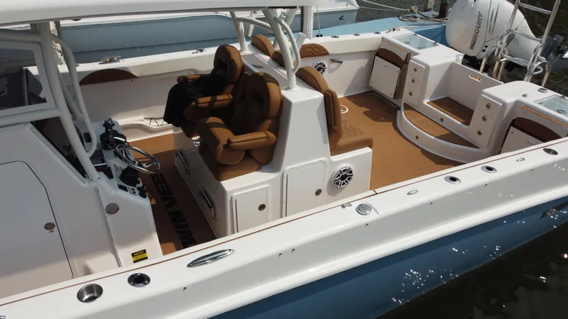 Slide: The Image of 2023 Twin Vee 340 GFX boat interior with brown seating and white deck. - 31