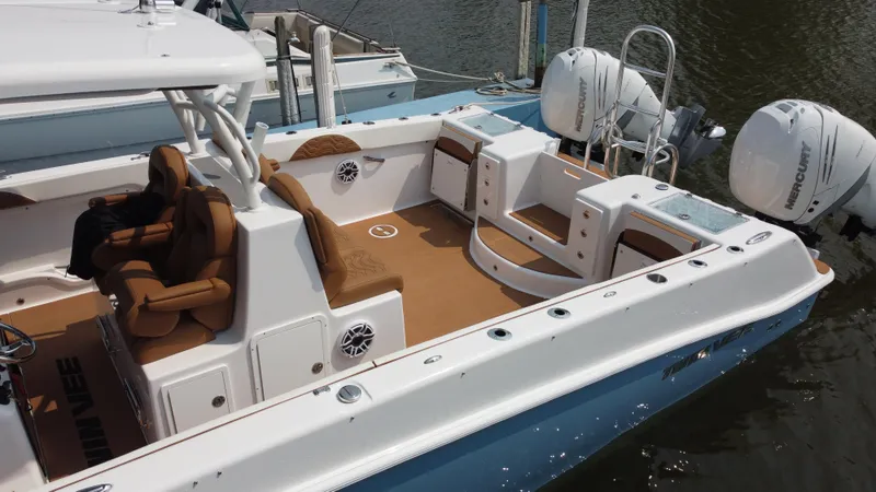 Slide: The Image of 2023 Twin Vee 340 GFX boat with twin outboard engines docked in water. - 32