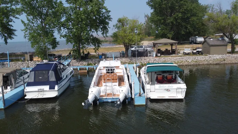 Slide: The Image of 2023 Twin Vee 340 GFX docked between other boats at a marina. - 39