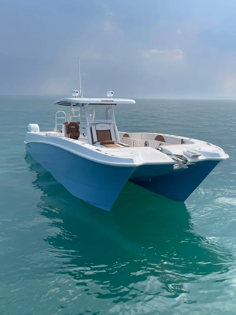 Slide: The Image of 2023 Twin Vee 340 GFX boat on calm ocean waters. - 4