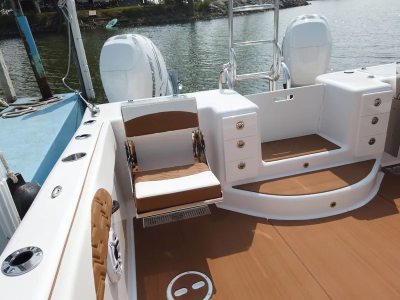 Slide: The Image of 2023 Twin Vee 340 GFX boat interior with seating and twin outboard engines. - 42