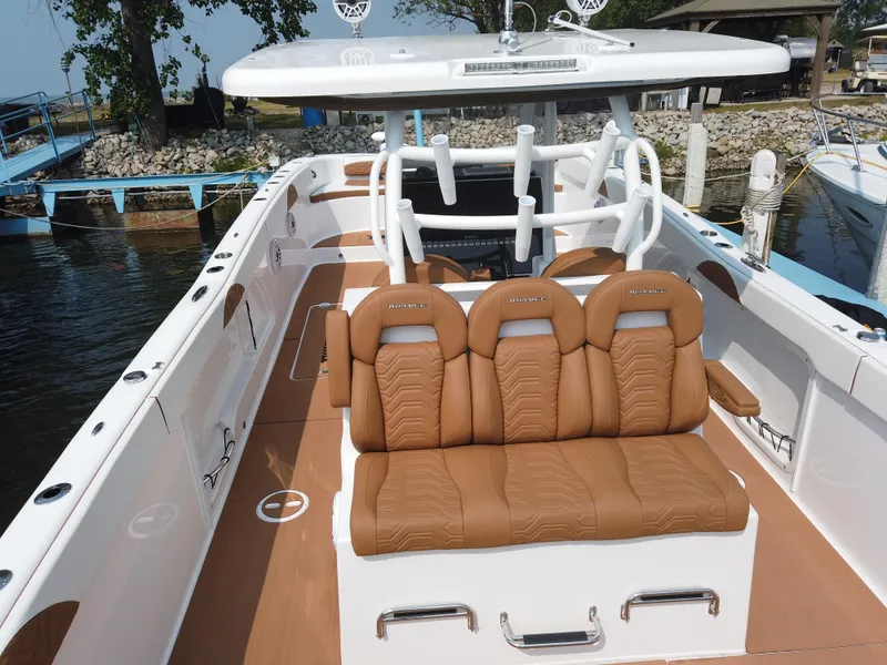 Slide: The Image of 2023 Twin Vee 340 GFX boat with luxurious brown leather seating at the dock. - 47