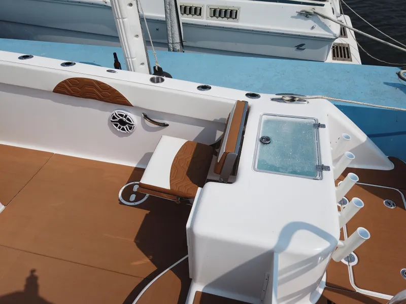 Slide: The Image of 2023 Twin Vee 340 GFX boat interior with seating and fishing rod holders. - 48