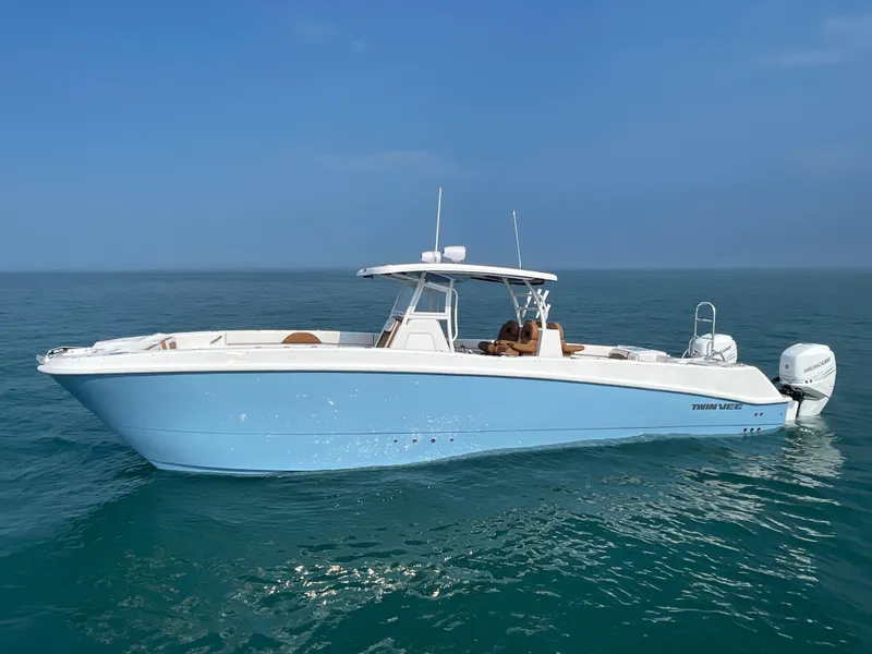 Slide: The Image of 2023 Twin Vee 340 GFX boat on calm ocean waters under clear blue sky. - 8