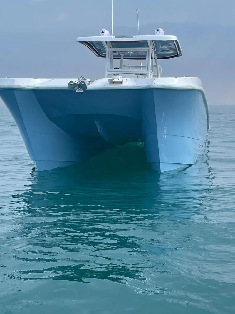 Slide: The Image of 2023 Twin Vee 340 GFX catamaran on calm ocean waters. - 9