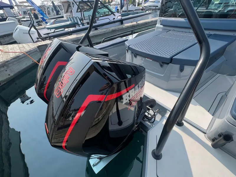 Slide: The Image of 2022 BRABUS Shadow 500 Cabin with dual outboard engines at a marina. - 11