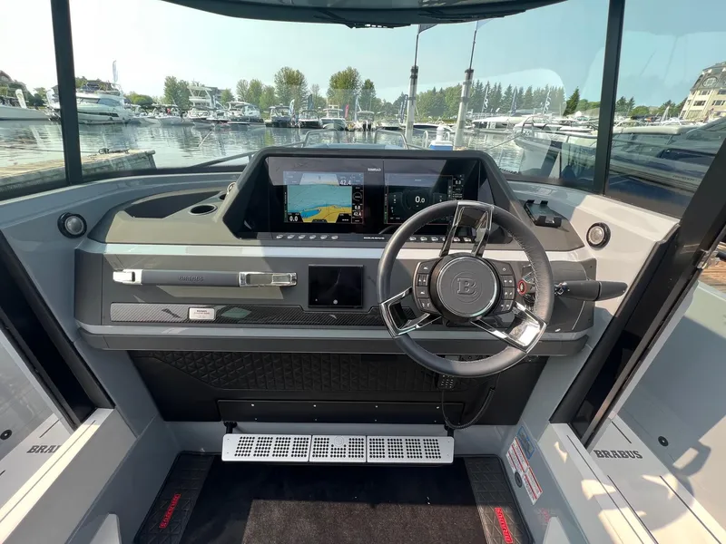 Slide: The Image of 2022 BRABUS Shadow 500 Cabin dashboard with steering wheel and navigation display. - 14